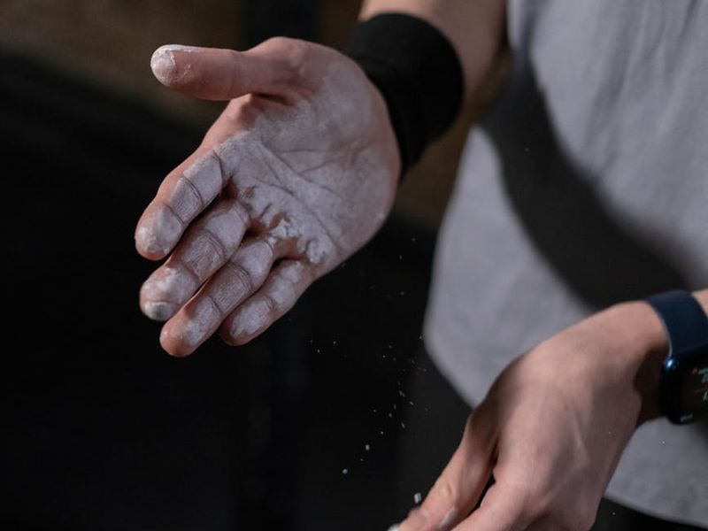 Close up of gym equipment and athlete preparing for workout