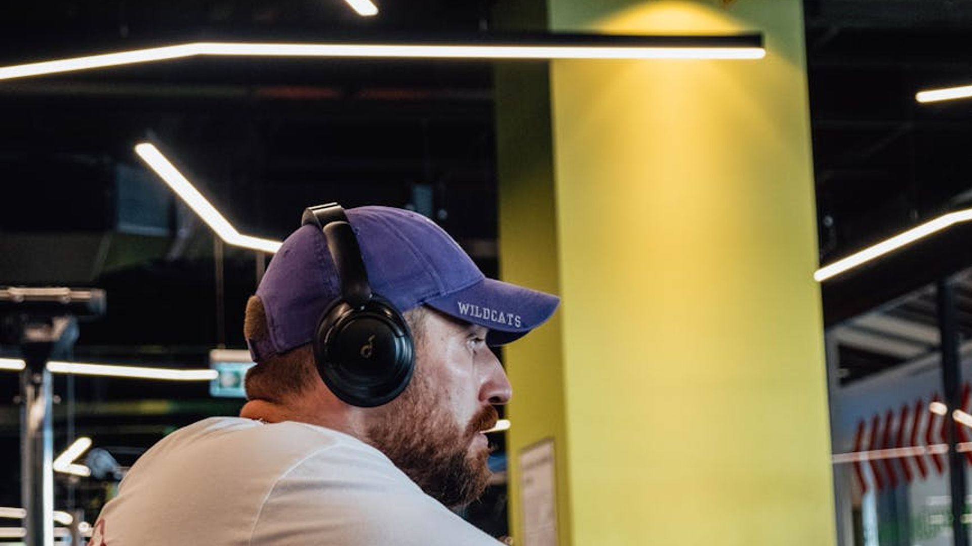 Man performing strength exercises in a modern gym setting